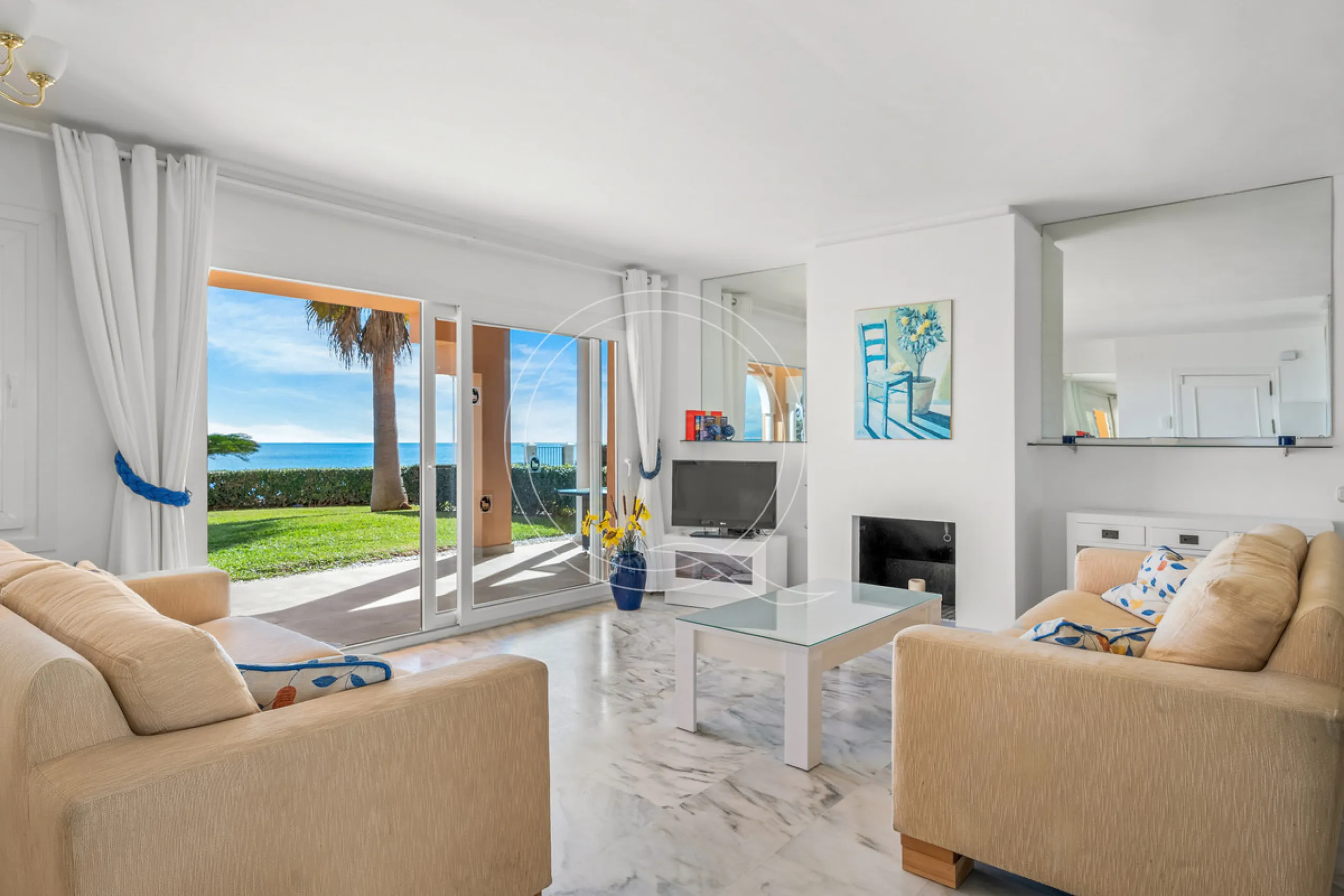Located in a prestigious front-line beach complex just west of Estepona, this three-bedroom ground-floor apartment offers an exceptional blend of coastal comfort and relaxed Mediterranean living. With direct access to the garden and just steps from the sa