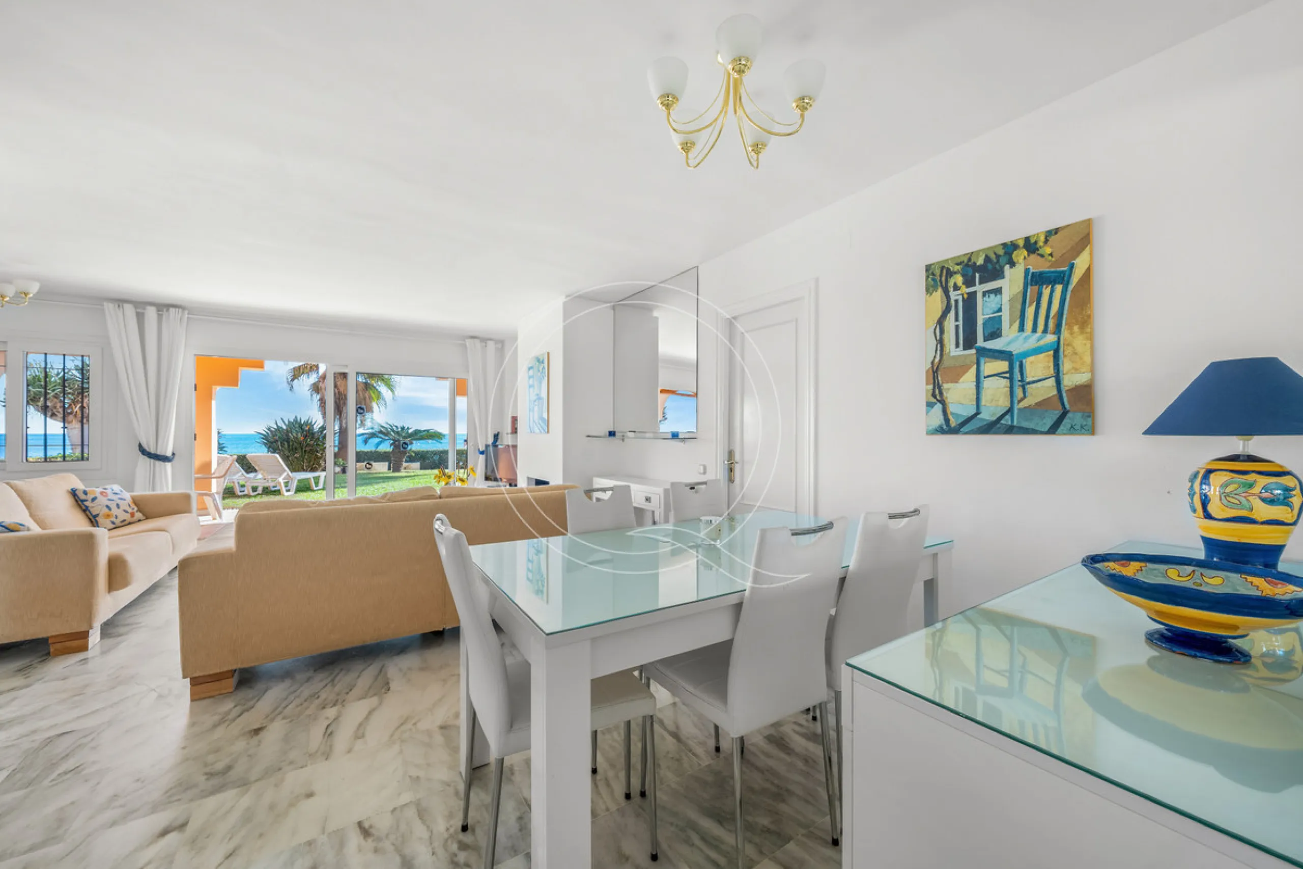 Located in a prestigious front-line beach complex just west of Estepona, this three-bedroom ground-floor apartment offers an exceptional blend of coastal comfort and relaxed Mediterranean living. With direct access to the garden and just steps from the sa