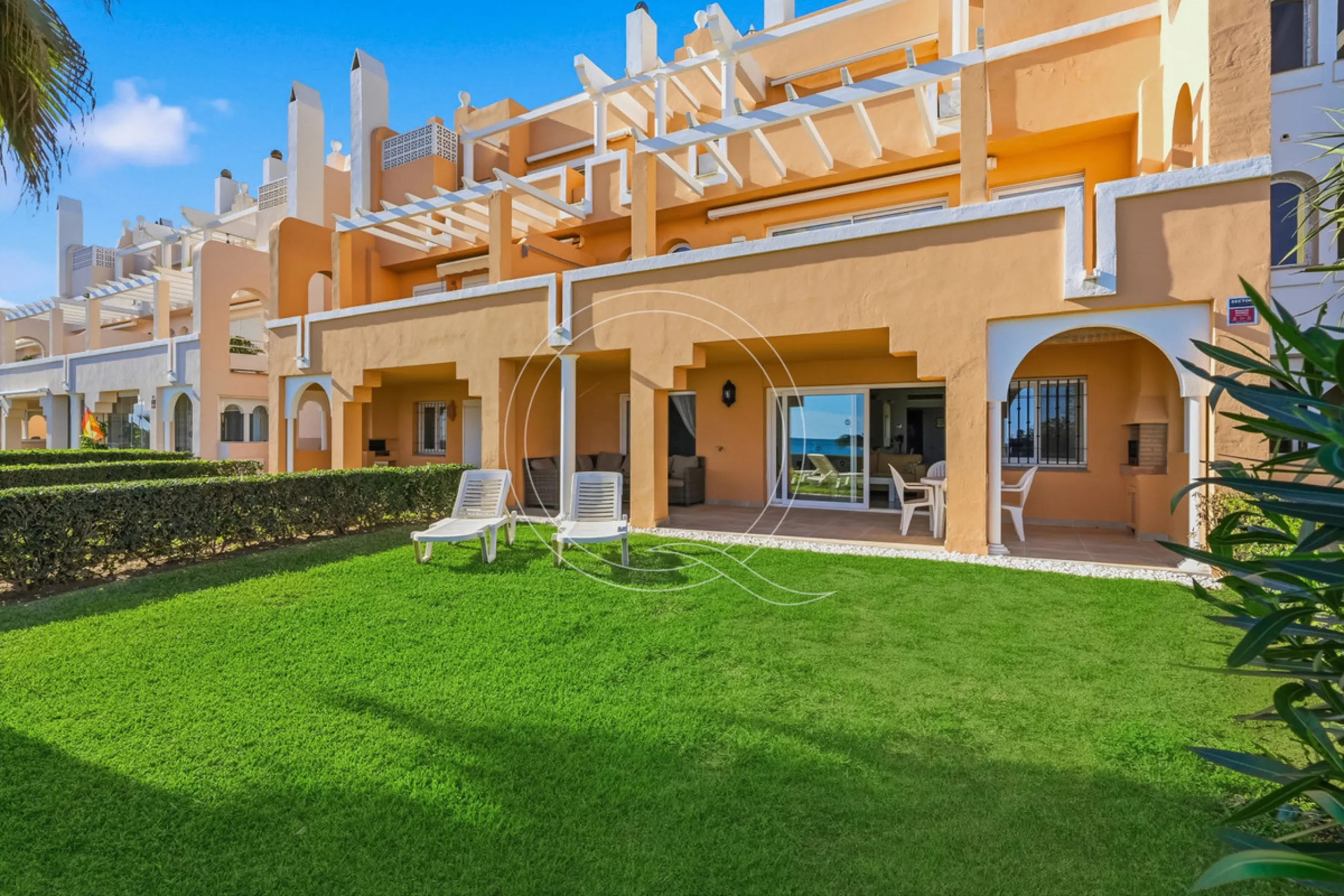 Located in a prestigious front-line beach complex just west of Estepona, this three-bedroom ground-floor apartment offers an exceptional blend of coastal comfort and relaxed Mediterranean living. With direct access to the garden and just steps from the sa
