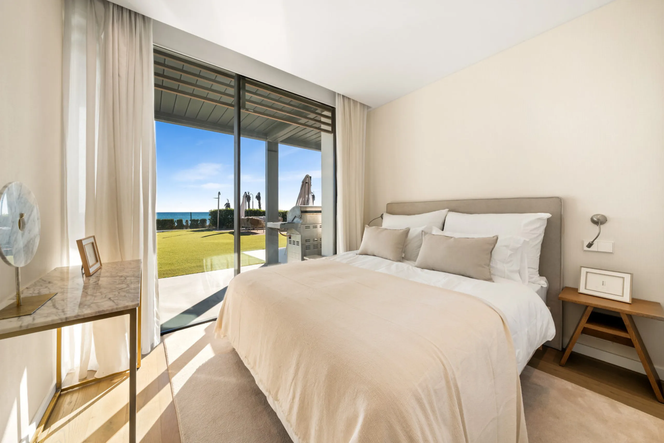 Boasting of panoramic sea views, a contemporary showpiece villa sitting in a privileged beachfront position in the New Golden Mile, surrounded by an expansive private garden with a large private swimming pool. The ideal family estate offering a dynamic ou