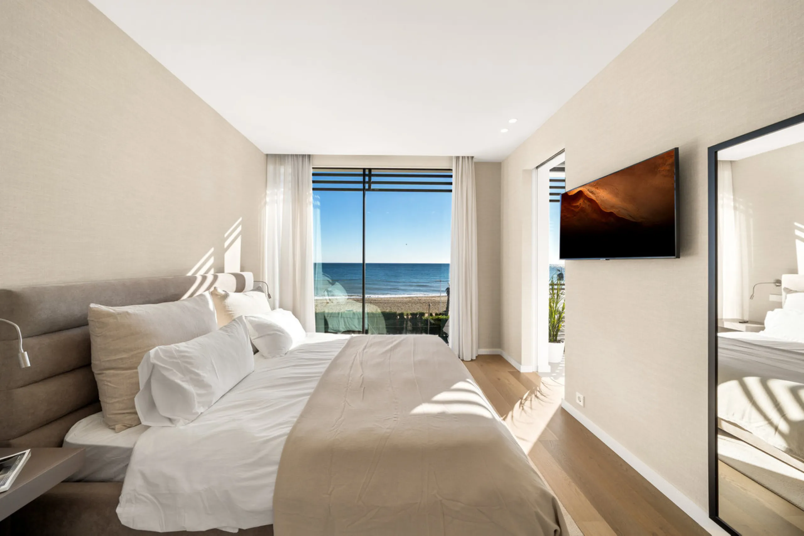 Boasting of panoramic sea views, a contemporary showpiece villa sitting in a privileged beachfront position in the New Golden Mile, surrounded by an expansive private garden with a large private swimming pool. The ideal family estate offering a dynamic ou