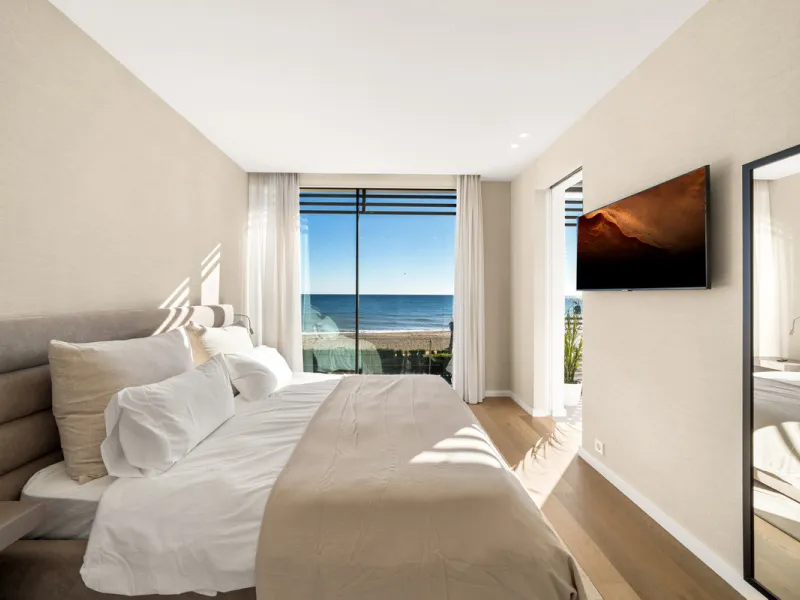 Boasting of panoramic sea views, a contemporary showpiece villa sitting in a privileged beachfront position in the New Golden Mile, surrounded by an expansive private garden with a large private swimming pool. The ideal family estate offering a dynamic ou
