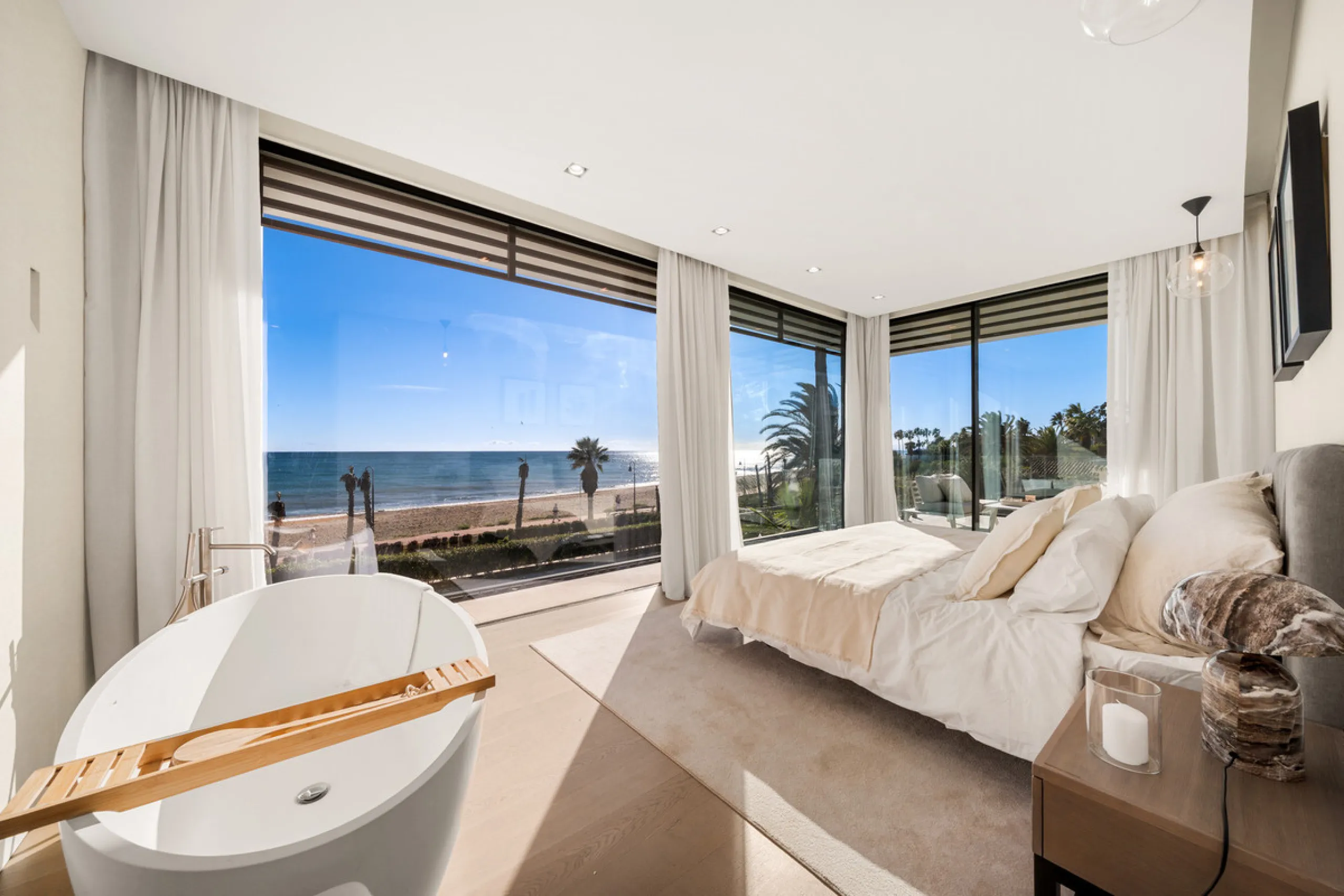 Boasting of panoramic sea views, a contemporary showpiece villa sitting in a privileged beachfront position in the New Golden Mile, surrounded by an expansive private garden with a large private swimming pool. The ideal family estate offering a dynamic ou