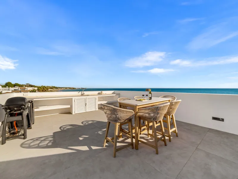 Boasting of panoramic sea views, a contemporary showpiece villa sitting in a privileged beachfront position in the New Golden Mile, surrounded by an expansive private garden with a large private swimming pool. The ideal family estate offering a dynamic ou