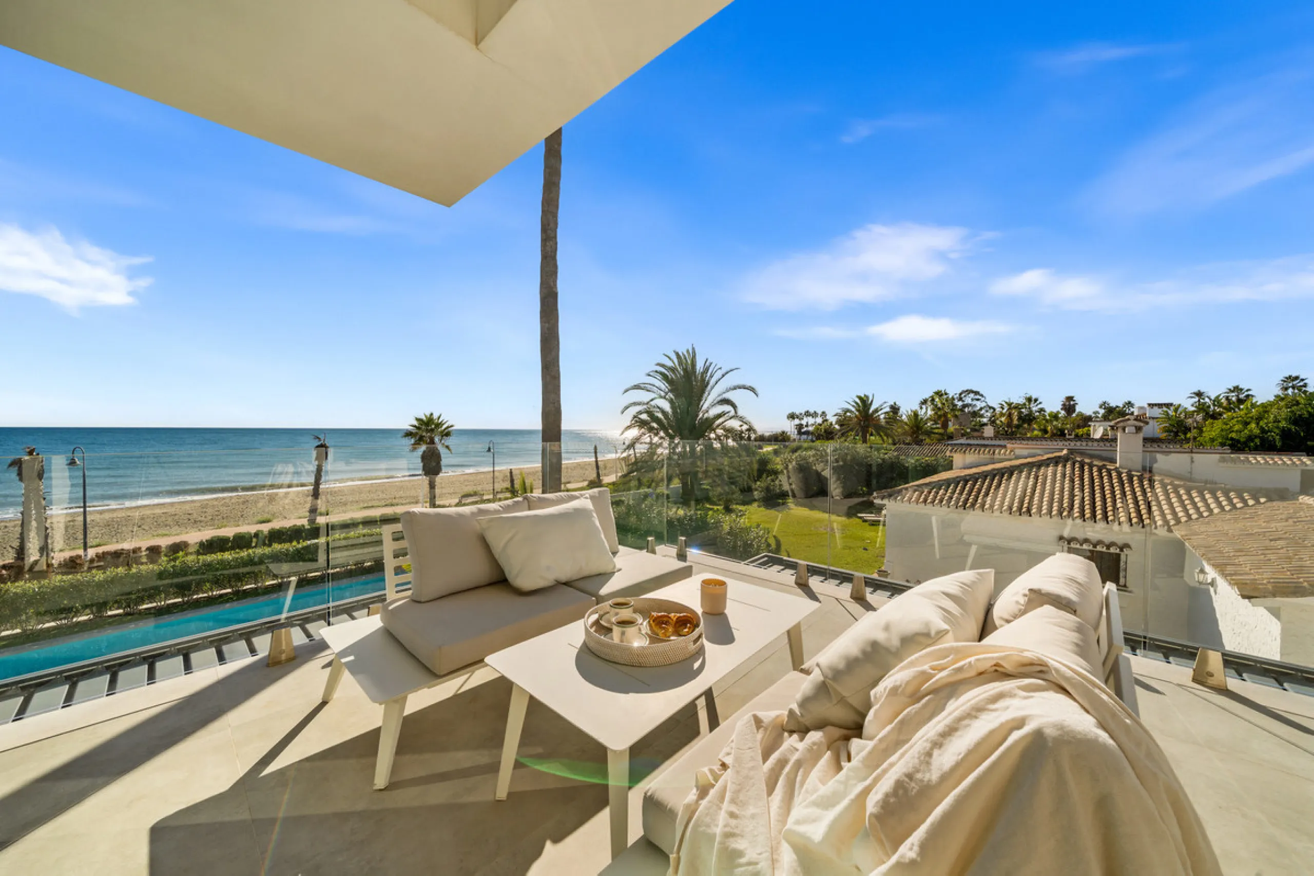 Boasting of panoramic sea views, a contemporary showpiece villa sitting in a privileged beachfront position in the New Golden Mile, surrounded by an expansive private garden with a large private swimming pool. The ideal family estate offering a dynamic ou