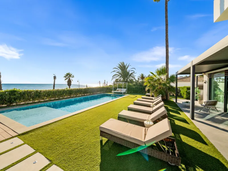 Boasting of panoramic sea views, a contemporary showpiece villa sitting in a privileged beachfront position in the New Golden Mile, surrounded by an expansive private garden with a large private swimming pool. The ideal family estate offering a dynamic ou