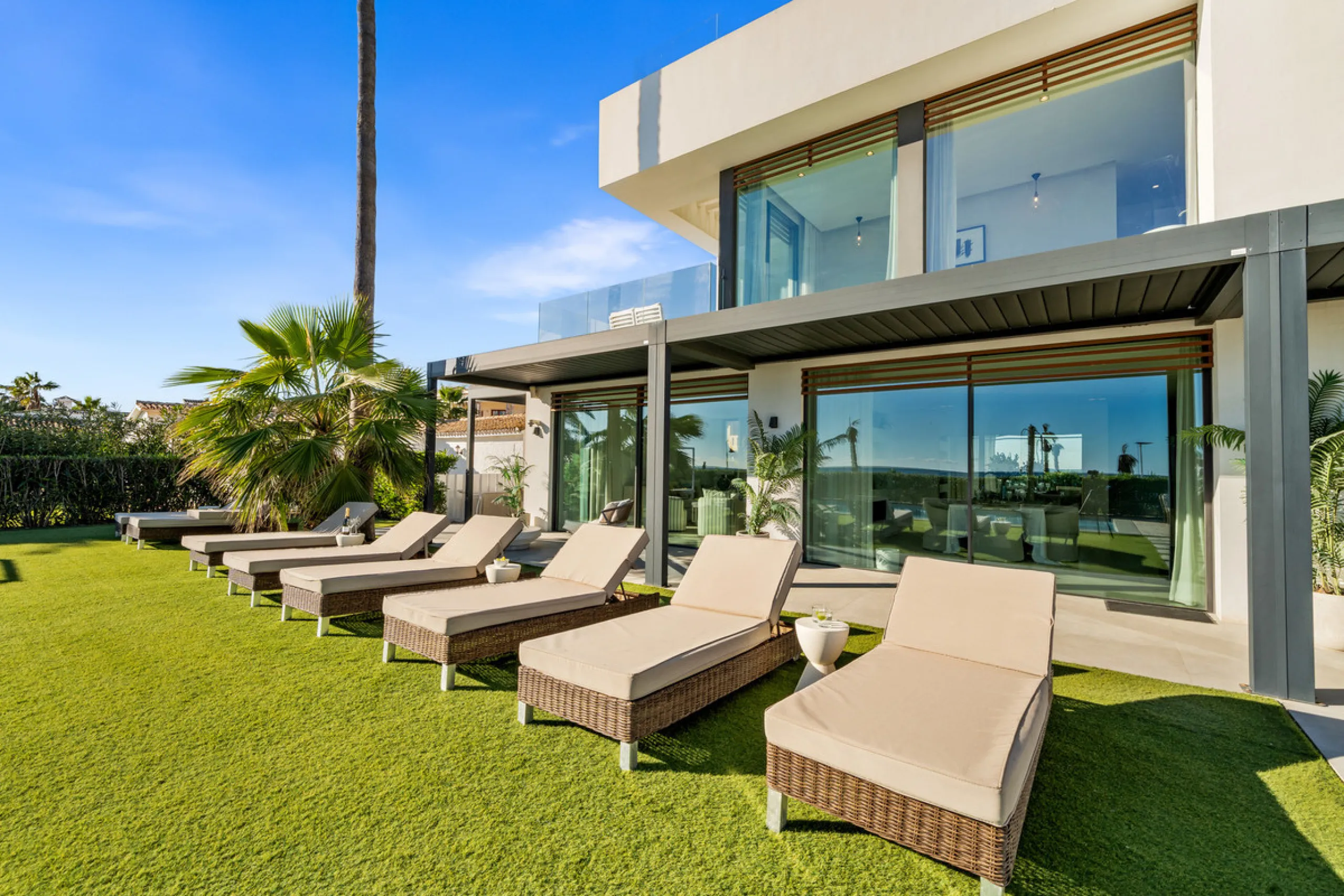 Boasting of panoramic sea views, a contemporary showpiece villa sitting in a privileged beachfront position in the New Golden Mile, surrounded by an expansive private garden with a large private swimming pool. The ideal family estate offering a dynamic ou