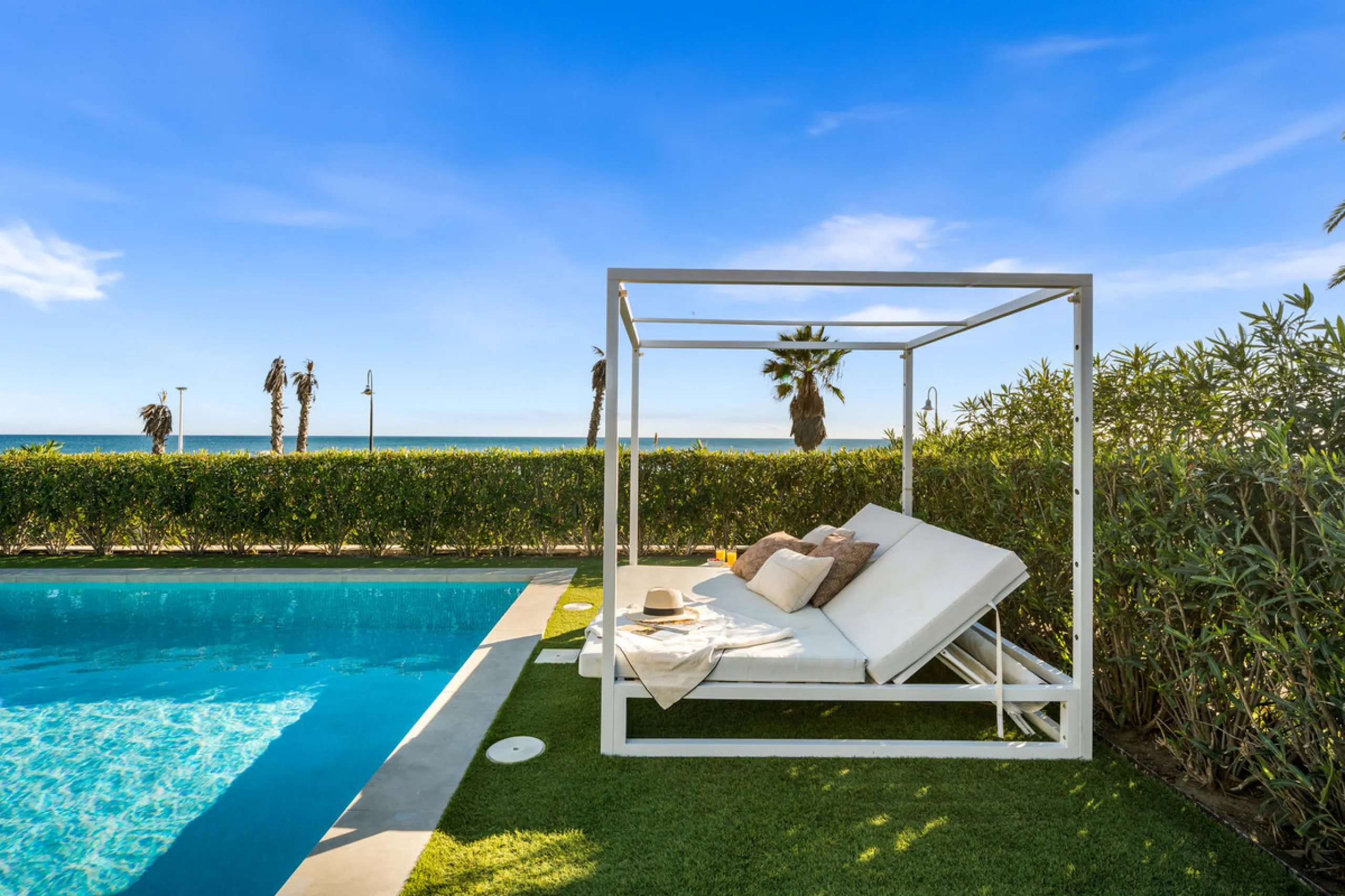 Boasting of panoramic sea views, a contemporary showpiece villa sitting in a privileged beachfront position in the New Golden Mile, surrounded by an expansive private garden with a large private swimming pool. The ideal family estate offering a dynamic ou