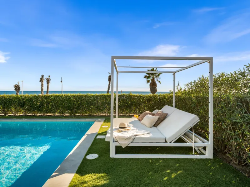 Boasting of panoramic sea views, a contemporary showpiece villa sitting in a privileged beachfront position in the New Golden Mile, surrounded by an expansive private garden with a large private swimming pool. The ideal family estate offering a dynamic ou