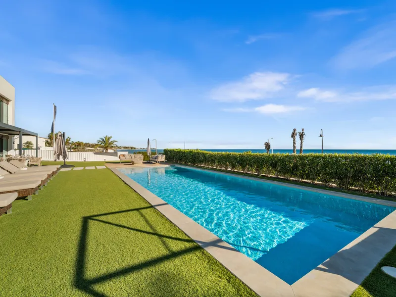 Boasting of panoramic sea views, a contemporary showpiece villa sitting in a privileged beachfront position in the New Golden Mile, surrounded by an expansive private garden with a large private swimming pool. The ideal family estate offering a dynamic ou