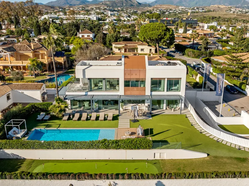 Boasting of panoramic sea views, a contemporary showpiece villa sitting in a privileged beachfront position in the New Golden Mile, surrounded by an expansive private garden with a large private swimming pool. The ideal family estate offering a dynamic ou