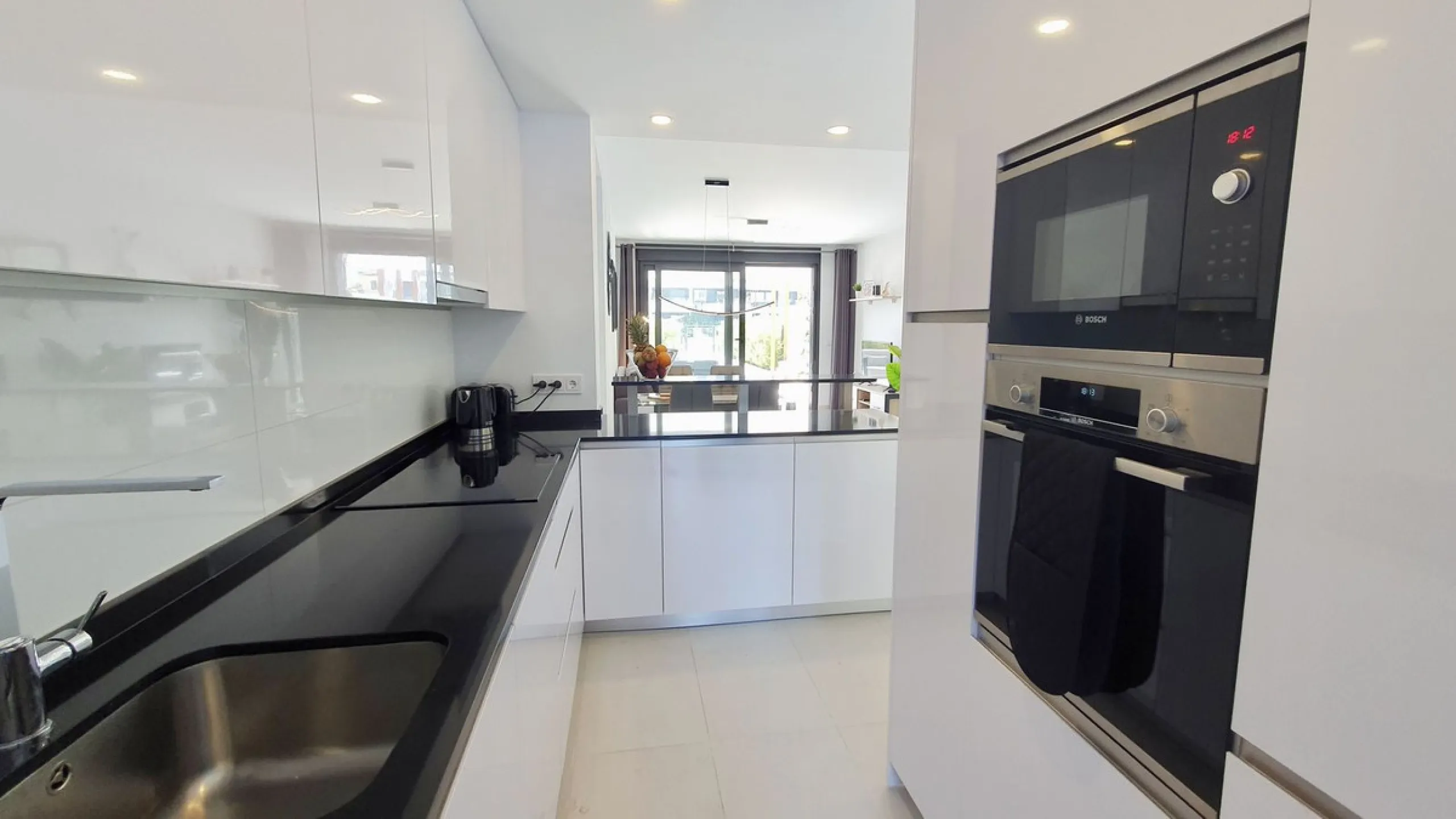 This stunning ground-floor apartment in Los Miradores del Sol Phase I perfectly combines contemporary luxury with Mediterranean indoor-outdoor living on Estepona's exclusive New Golden Mile. Offering 92 m² of elegant interior space and an impressive 84 m²