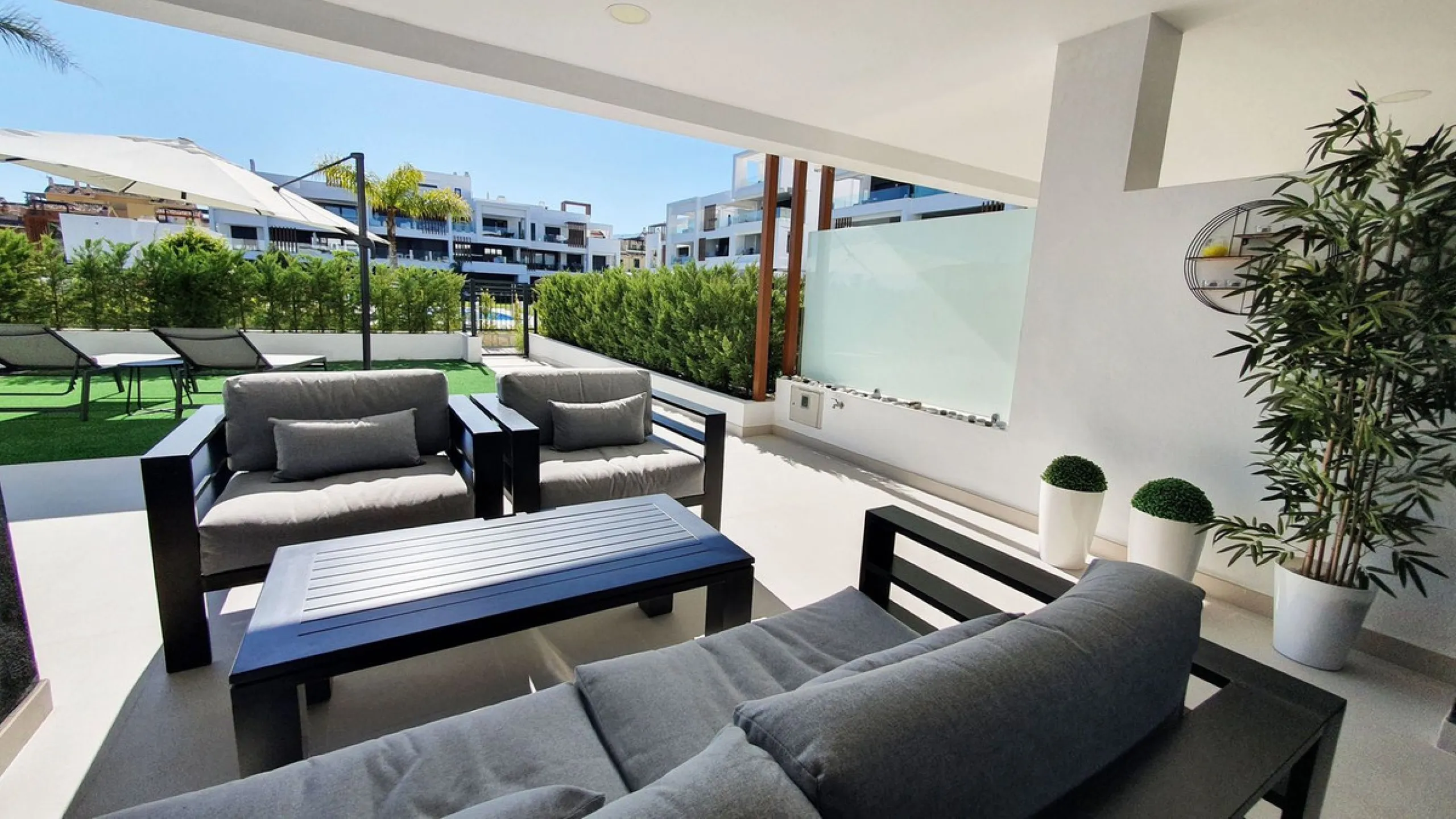 This stunning ground-floor apartment in Los Miradores del Sol Phase I perfectly combines contemporary luxury with Mediterranean indoor-outdoor living on Estepona's exclusive New Golden Mile. Offering 92 m² of elegant interior space and an impressive 84 m²