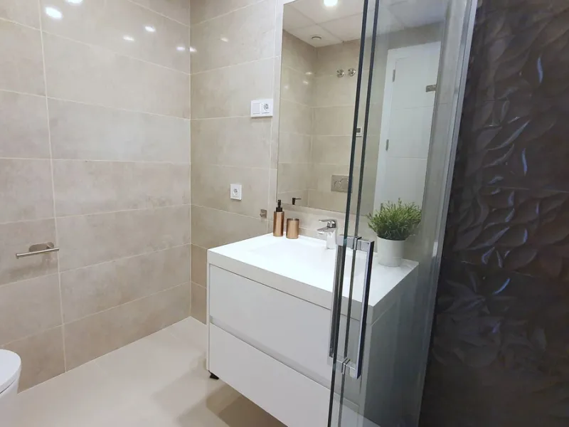 This stunning ground-floor apartment in Los Miradores del Sol Phase I perfectly combines contemporary luxury with Mediterranean indoor-outdoor living on Estepona's exclusive New Golden Mile. Offering 92 m² of elegant interior space and an impressive 84 m²