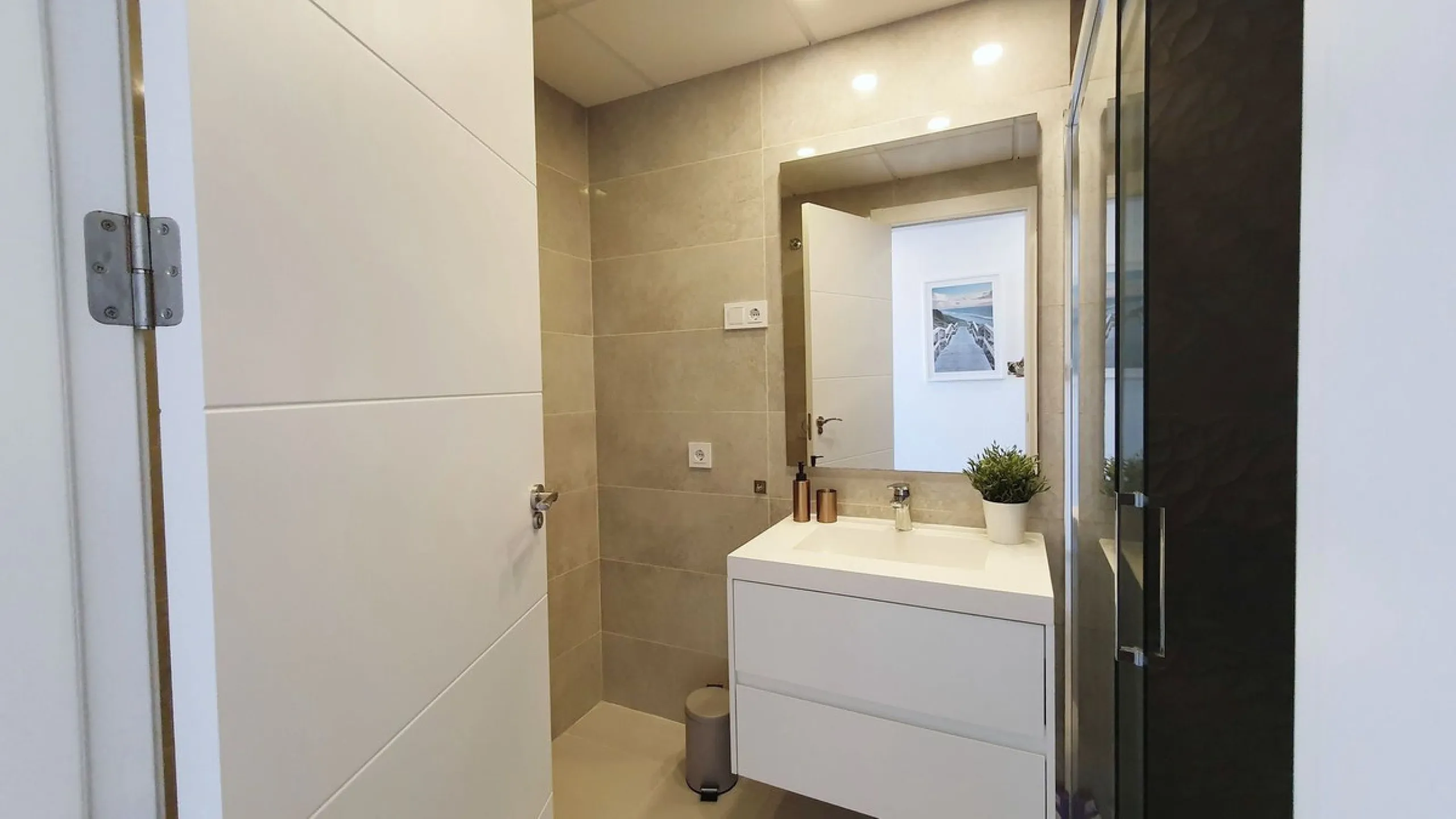 This stunning ground-floor apartment in Los Miradores del Sol Phase I perfectly combines contemporary luxury with Mediterranean indoor-outdoor living on Estepona's exclusive New Golden Mile. Offering 92 m² of elegant interior space and an impressive 84 m²