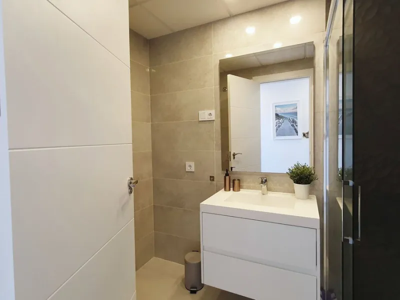 This stunning ground-floor apartment in Los Miradores del Sol Phase I perfectly combines contemporary luxury with Mediterranean indoor-outdoor living on Estepona's exclusive New Golden Mile. Offering 92 m² of elegant interior space and an impressive 84 m²