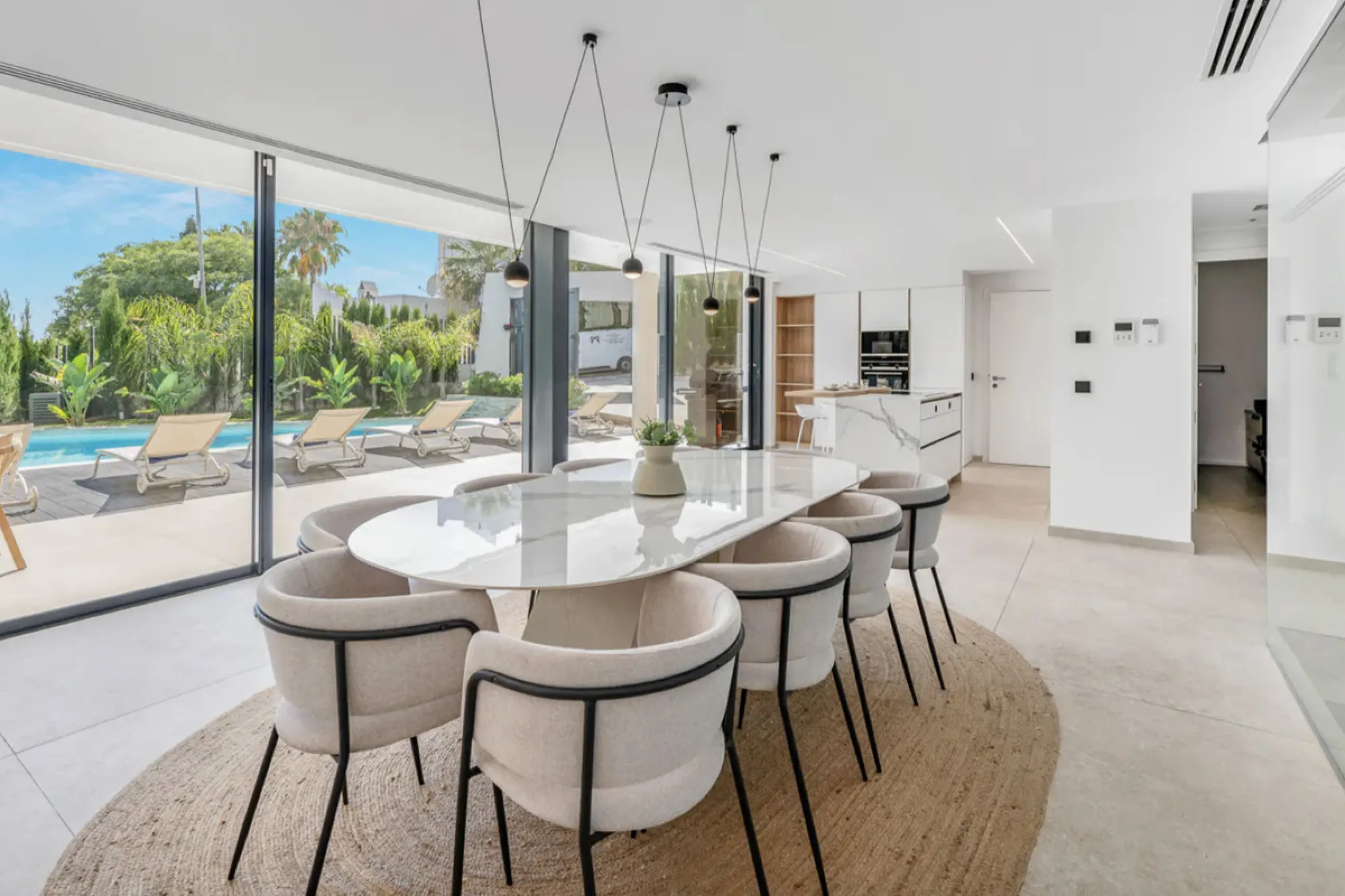 This stunning property is a modern luxury home in Reserva Marbella with open sea views and a bright open-plan design. The ground floor connects the kitchen, dining and living areas in one clean space that leads to a covered terrace, a landscaped garden an