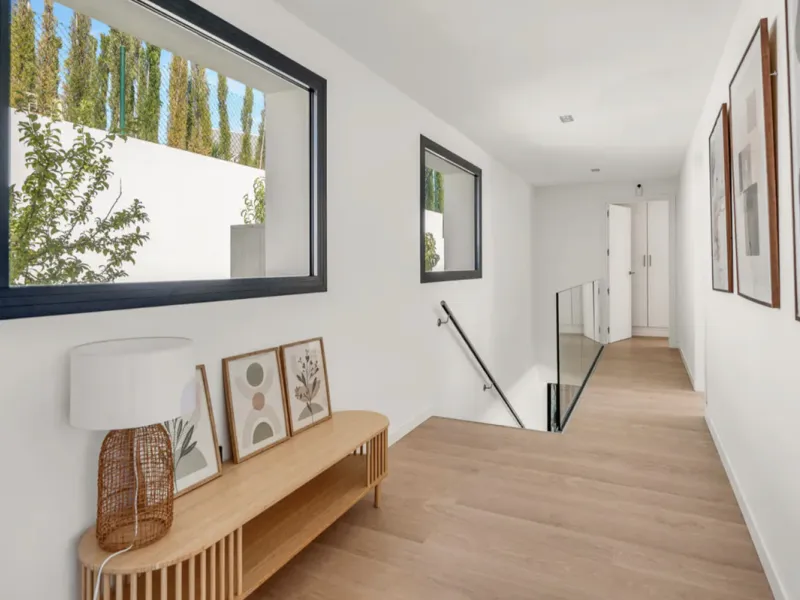 This stunning property is a modern luxury home in Reserva Marbella with open sea views and a bright open-plan design. The ground floor connects the kitchen, dining and living areas in one clean space that leads to a covered terrace, a landscaped garden an