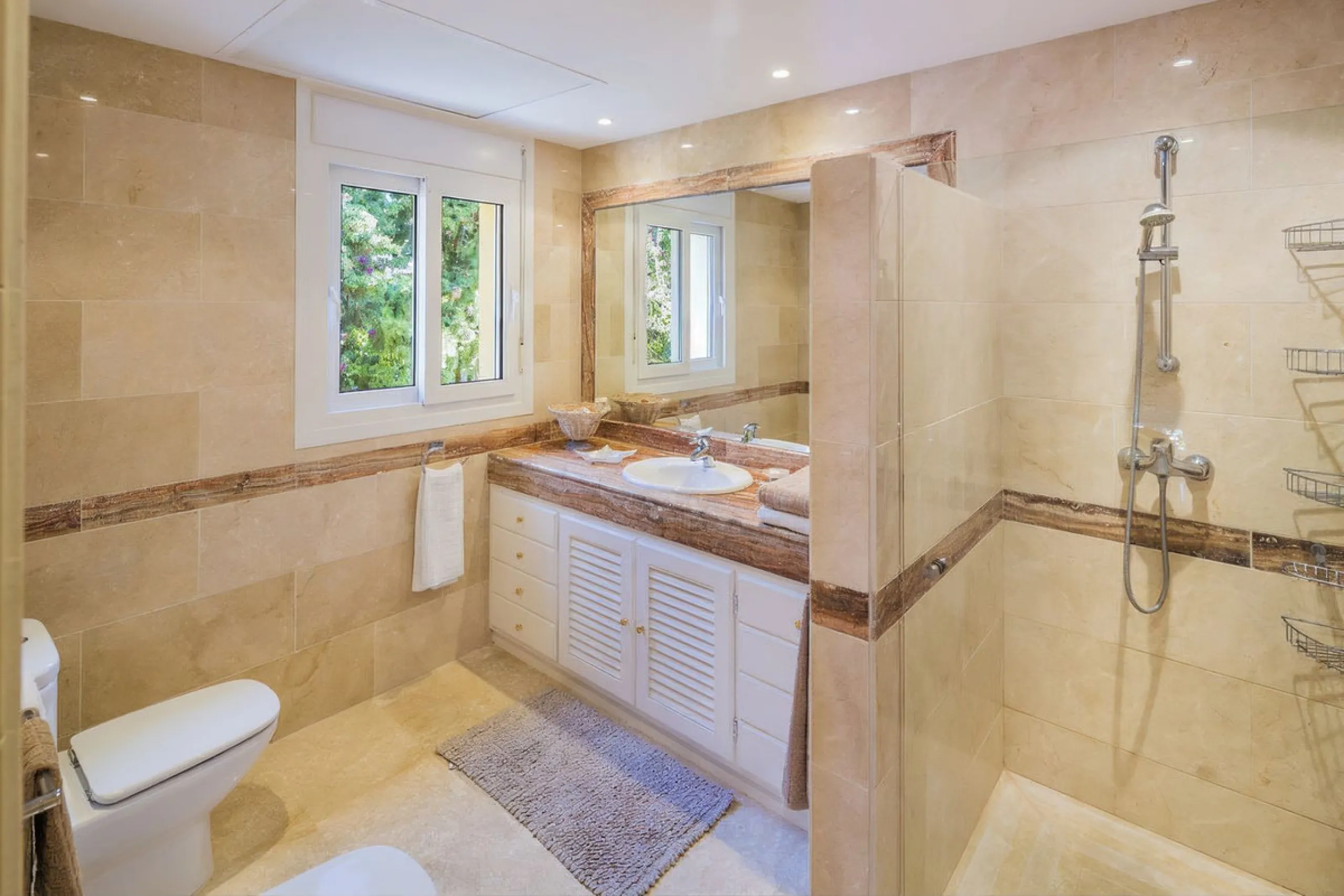 This beautifully decorated villa is comprised of a grand hallway, fully equipped kitchen with a breakfast area, a spacious dining room / lounge with a fireplace and access to the terrace and garden, 4 ample bedrooms with en-suite bathrooms and a guest res