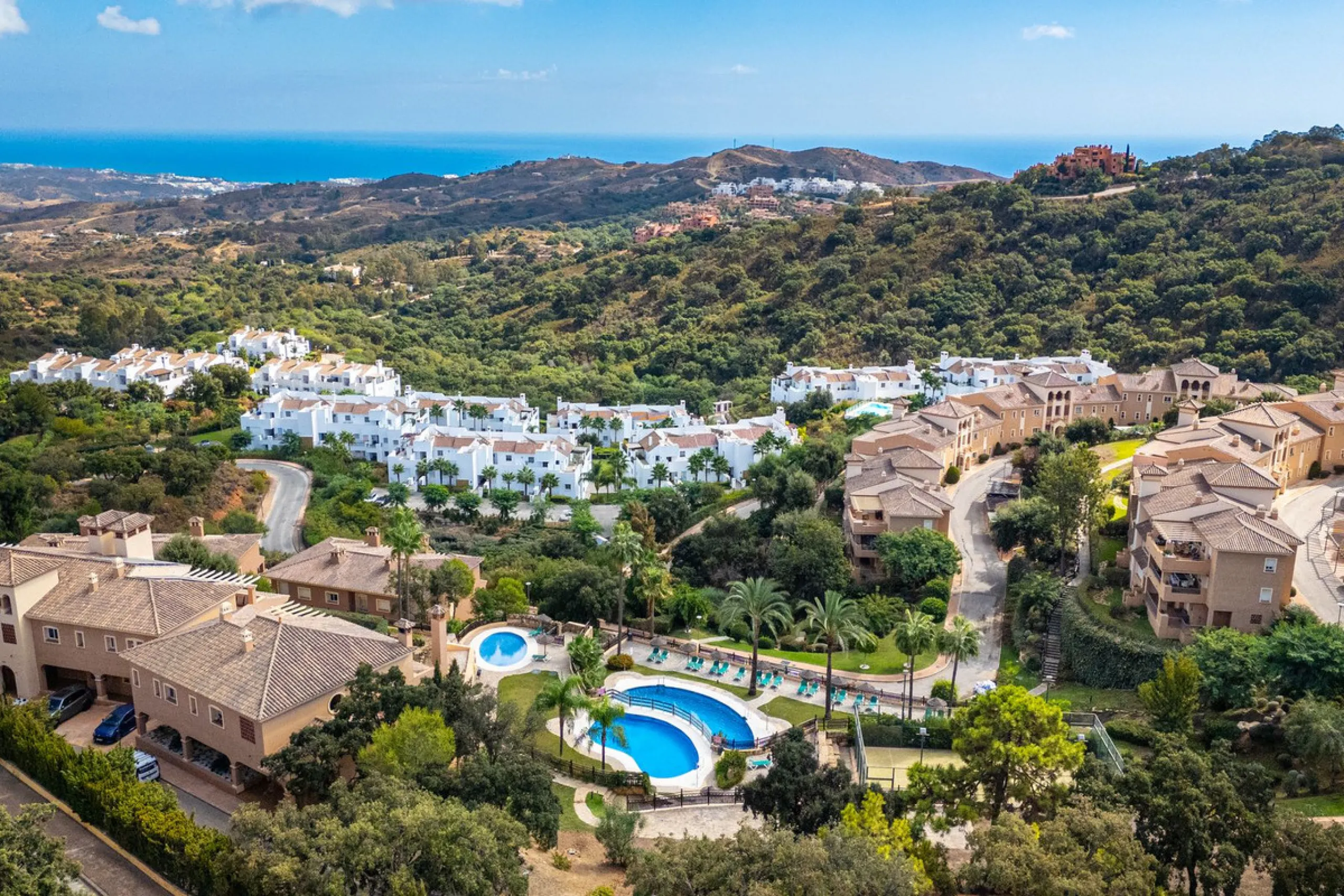 Discover this beautiful 2-bedroom 'penthouse-like feel' middle-floor apartment perfectly positioned in the prestigious enclave of La Mairena / Elviria Alta on Marbella's sought-after east coast. Surrounded by natural beauty, SEA and mountain views, this e