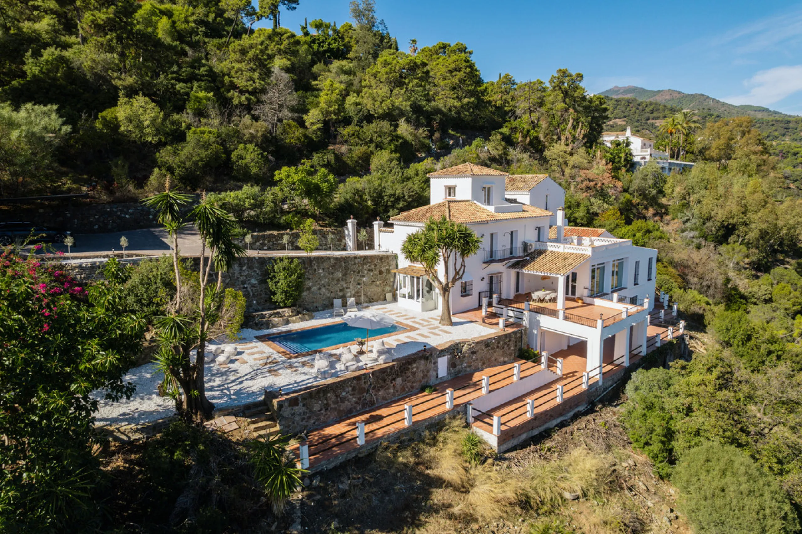 Villa in El Madroñal for sale, offering refined living within the exclusive gated community of El Madroñal 2 in Benahavís, Málaga. This six-bedroom villa with five ensuite bathrooms combines traditional Andalusian features with contemporary design. Built 