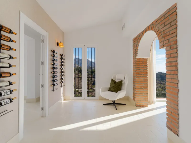 Villa in El Madroñal for sale, offering refined living within the exclusive gated community of El Madroñal 2 in Benahavís, Málaga. This six-bedroom villa with five ensuite bathrooms combines traditional Andalusian features with contemporary design. Built 