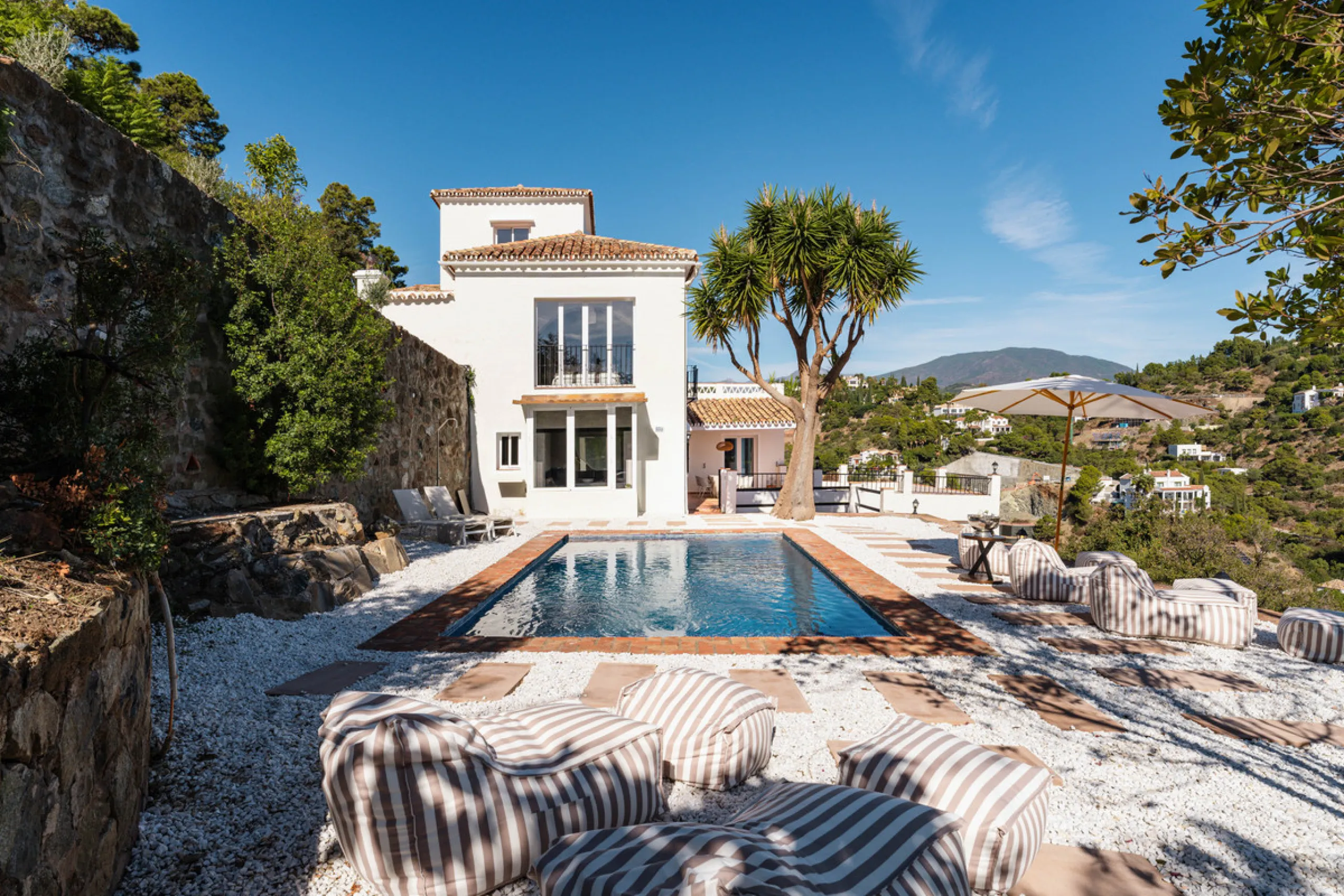 Villa in El Madroñal for sale, offering refined living within the exclusive gated community of El Madroñal 2 in Benahavís, Málaga. This six-bedroom villa with five ensuite bathrooms combines traditional Andalusian features with contemporary design. Built 