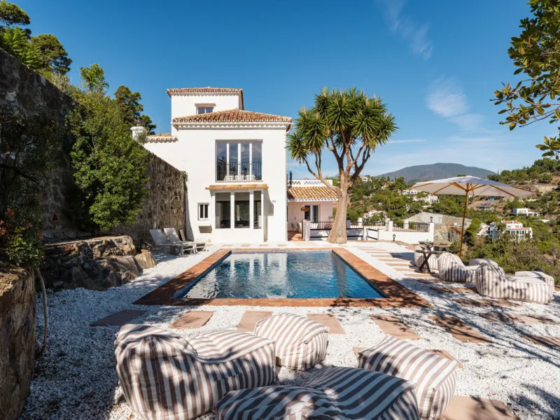 Villa in El Madroñal for sale, offering refined living within the exclusive gated community of El Madroñal 2 in Benahavís, Málaga. This six-bedroom villa with five ensuite bathrooms combines traditional Andalusian features with contemporary design. Built 