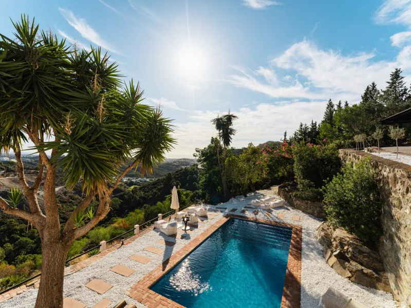 Villa in El Madroñal for sale, offering refined living within the exclusive gated community of El Madroñal 2 in Benahavís, Málaga. This six-bedroom villa with five ensuite bathrooms combines traditional Andalusian features with contemporary design. Built 