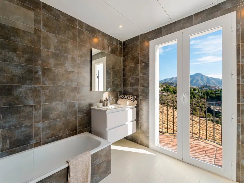 Villa in El Madroñal for sale, offering refined living within the exclusive gated community of El Madroñal 2 in Benahavís, Málaga. This six-bedroom villa with five ensuite bathrooms combines traditional Andalusian features with contemporary design. Built 