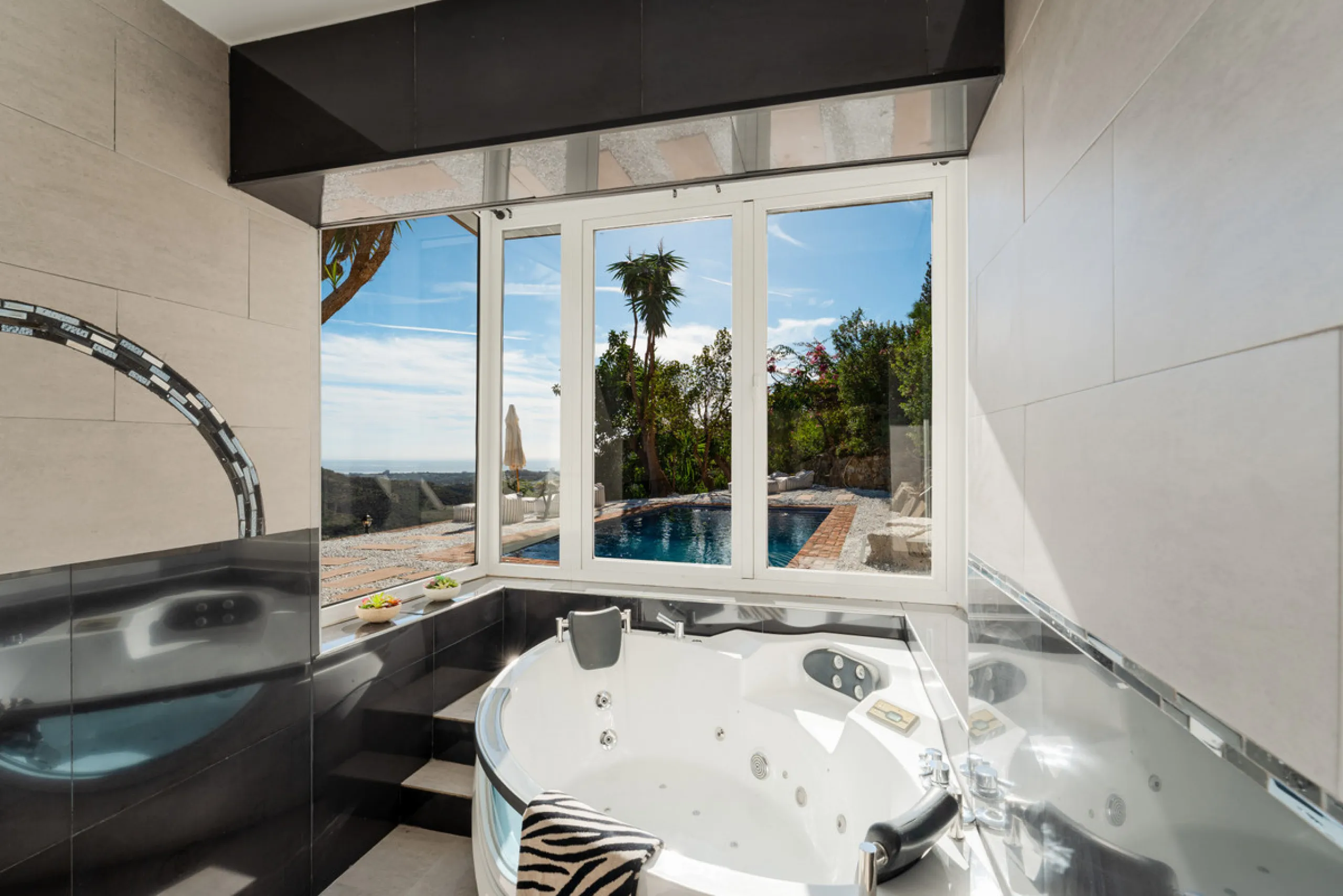 Villa in El Madroñal for sale, offering refined living within the exclusive gated community of El Madroñal 2 in Benahavís, Málaga. This six-bedroom villa with five ensuite bathrooms combines traditional Andalusian features with contemporary design. Built 