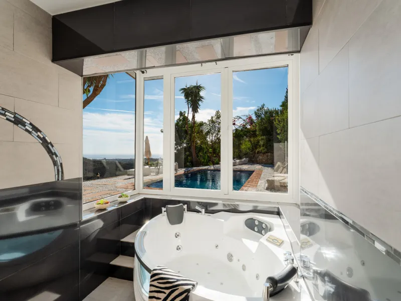 Villa in El Madroñal for sale, offering refined living within the exclusive gated community of El Madroñal 2 in Benahavís, Málaga. This six-bedroom villa with five ensuite bathrooms combines traditional Andalusian features with contemporary design. Built 