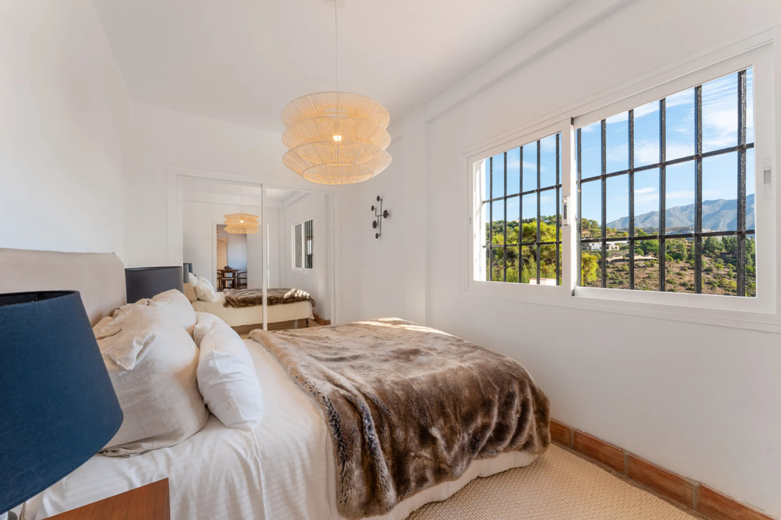 Villa in El Madroñal for sale, offering refined living within the exclusive gated community of El Madroñal 2 in Benahavís, Málaga. This six-bedroom villa with five ensuite bathrooms combines traditional Andalusian features with contemporary design. Built 