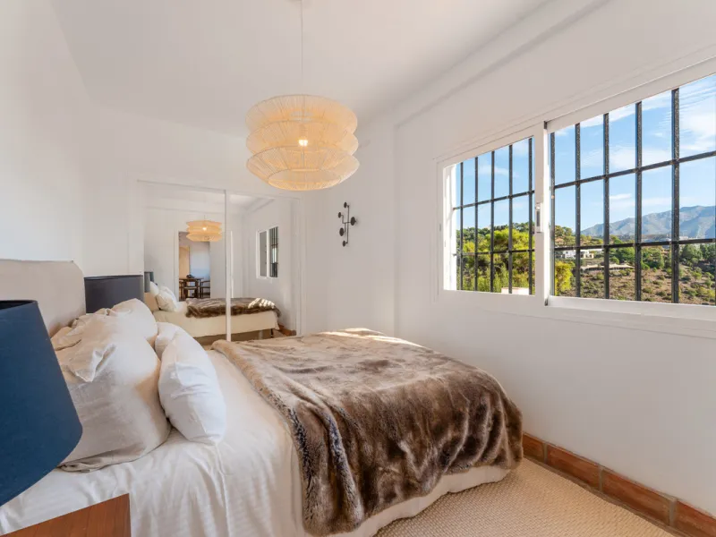 Villa in El Madroñal for sale, offering refined living within the exclusive gated community of El Madroñal 2 in Benahavís, Málaga. This six-bedroom villa with five ensuite bathrooms combines traditional Andalusian features with contemporary design. Built 