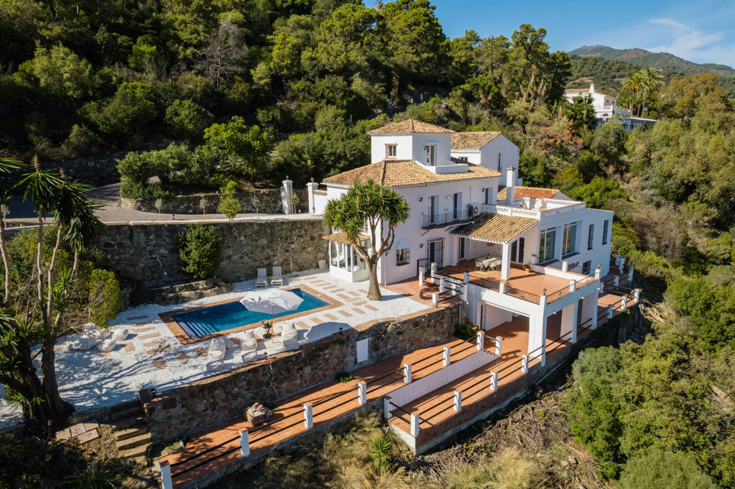 Villa in El Madroñal for sale, offering refined living within the exclusive gated community of El Madroñal 2 in Benahavís, Málaga. This six-bedroom villa with five ensuite bathrooms combines traditional Andalusian features with contemporary design. Built 