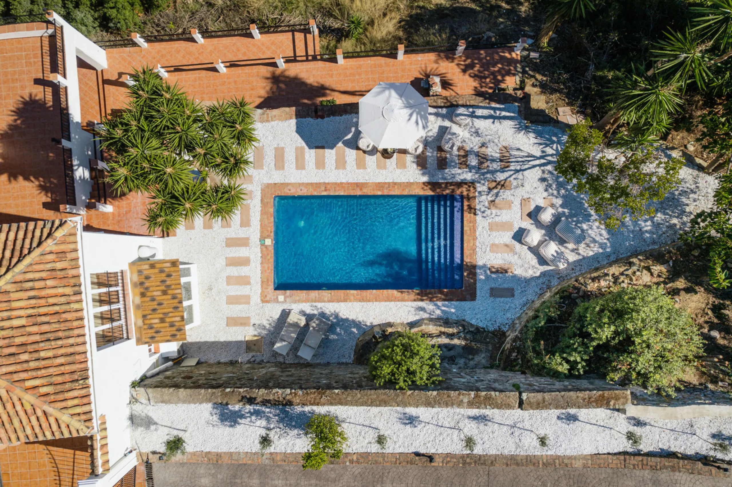 Villa in El Madroñal for sale, offering refined living within the exclusive gated community of El Madroñal 2 in Benahavís, Málaga. This six-bedroom villa with five ensuite bathrooms combines traditional Andalusian features with contemporary design. Built 