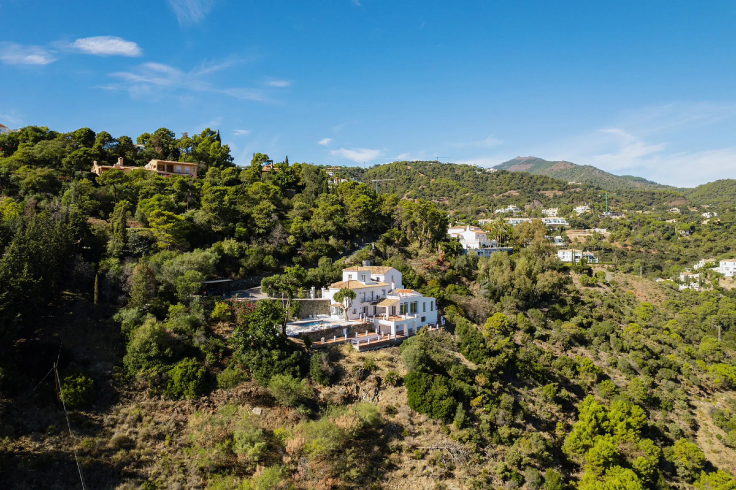 Villa in El Madroñal for sale, offering refined living within the exclusive gated community of El Madroñal 2 in Benahavís, Málaga. This six-bedroom villa with five ensuite bathrooms combines traditional Andalusian features with contemporary design. Built 