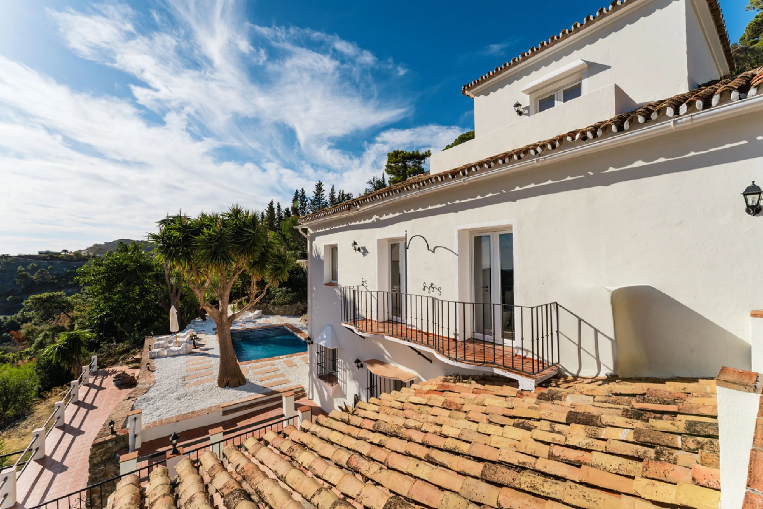 Villa in El Madroñal for sale, offering refined living within the exclusive gated community of El Madroñal 2 in Benahavís, Málaga. This six-bedroom villa with five ensuite bathrooms combines traditional Andalusian features with contemporary design. Built 