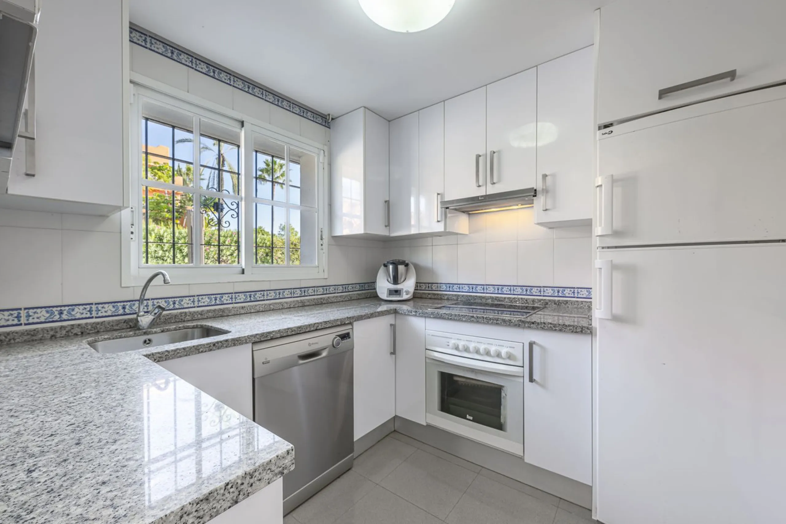 This stunning semi-detached villa is located in a traditional Andalusian development on the New Golden Mile. It is ideally located a short drive from Puerto Banús, with the beach just a short walk away.