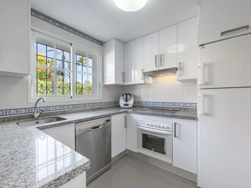 This stunning semi-detached villa is located in a traditional Andalusian development on the New Golden Mile. It is ideally located a short drive from Puerto Banús, with the beach just a short walk away.
