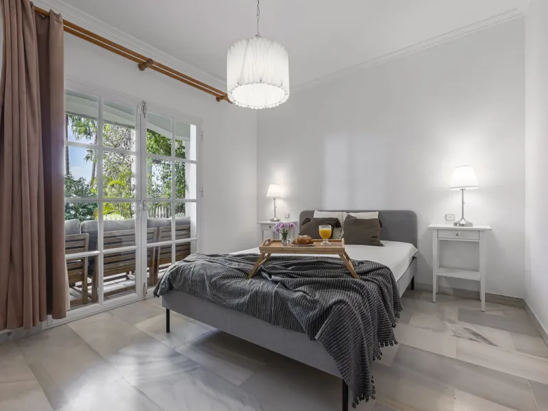 This stunning semi-detached villa is located in a traditional Andalusian development on the New Golden Mile. It is ideally located a short drive from Puerto Banús, with the beach just a short walk away.