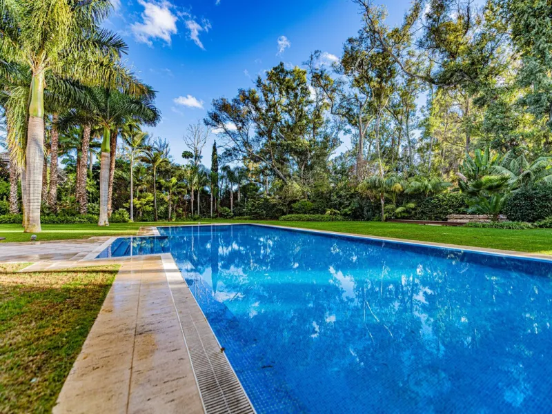 Luxury andalusian style villa that resides magnificently in one of the most prestigious and sought-after urbanizations in Marbella, Guadalmina Baja, only 100 meters from the beach and 5 minutes from Puerto Banus. The highest quality materials have been us