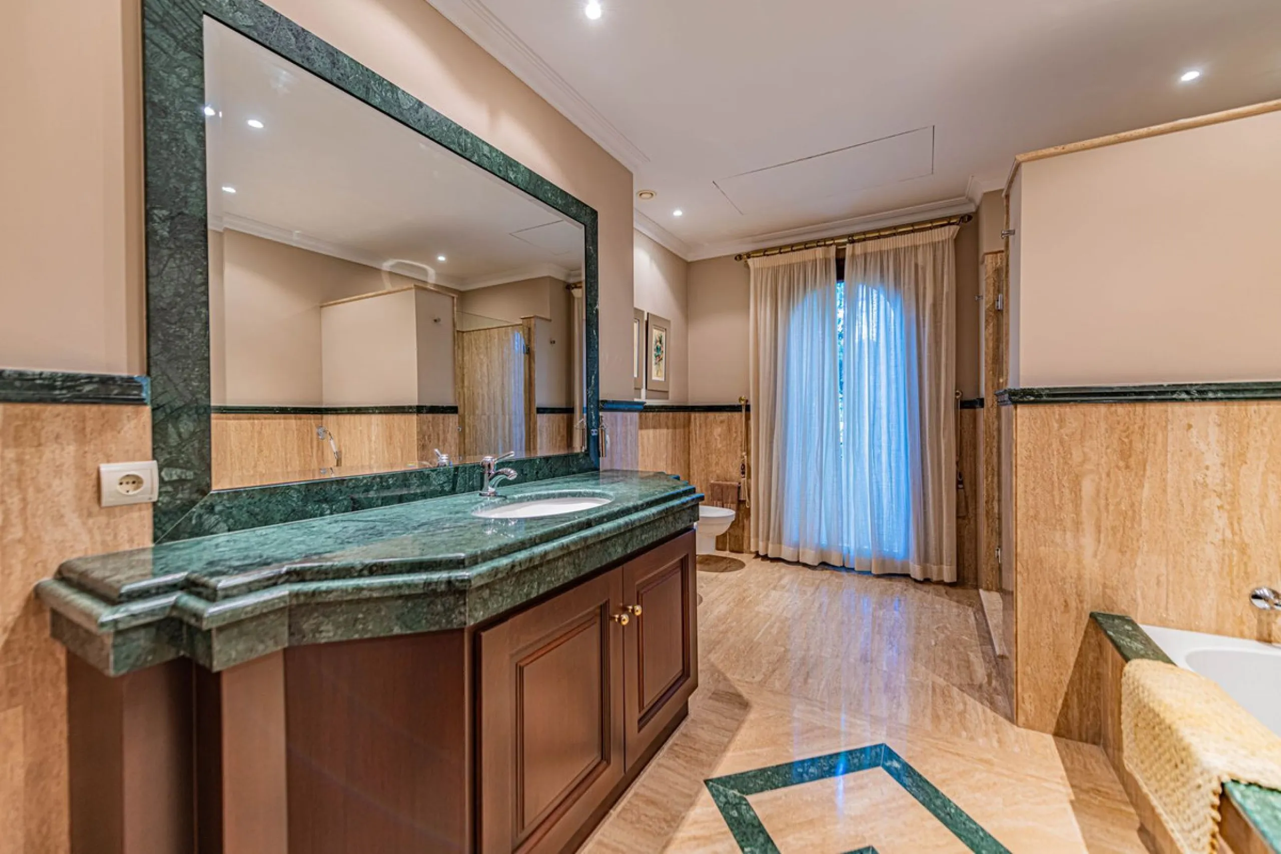 Luxury andalusian style villa that resides magnificently in one of the most prestigious and sought-after urbanizations in Marbella, Guadalmina Baja, only 100 meters from the beach and 5 minutes from Puerto Banus. The highest quality materials have been us