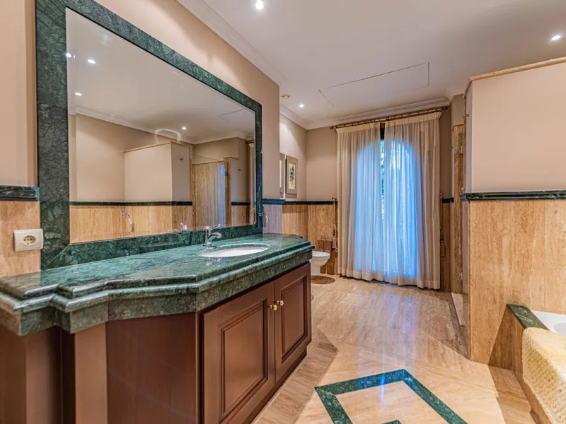 Luxury andalusian style villa that resides magnificently in one of the most prestigious and sought-after urbanizations in Marbella, Guadalmina Baja, only 100 meters from the beach and 5 minutes from Puerto Banus. The highest quality materials have been us