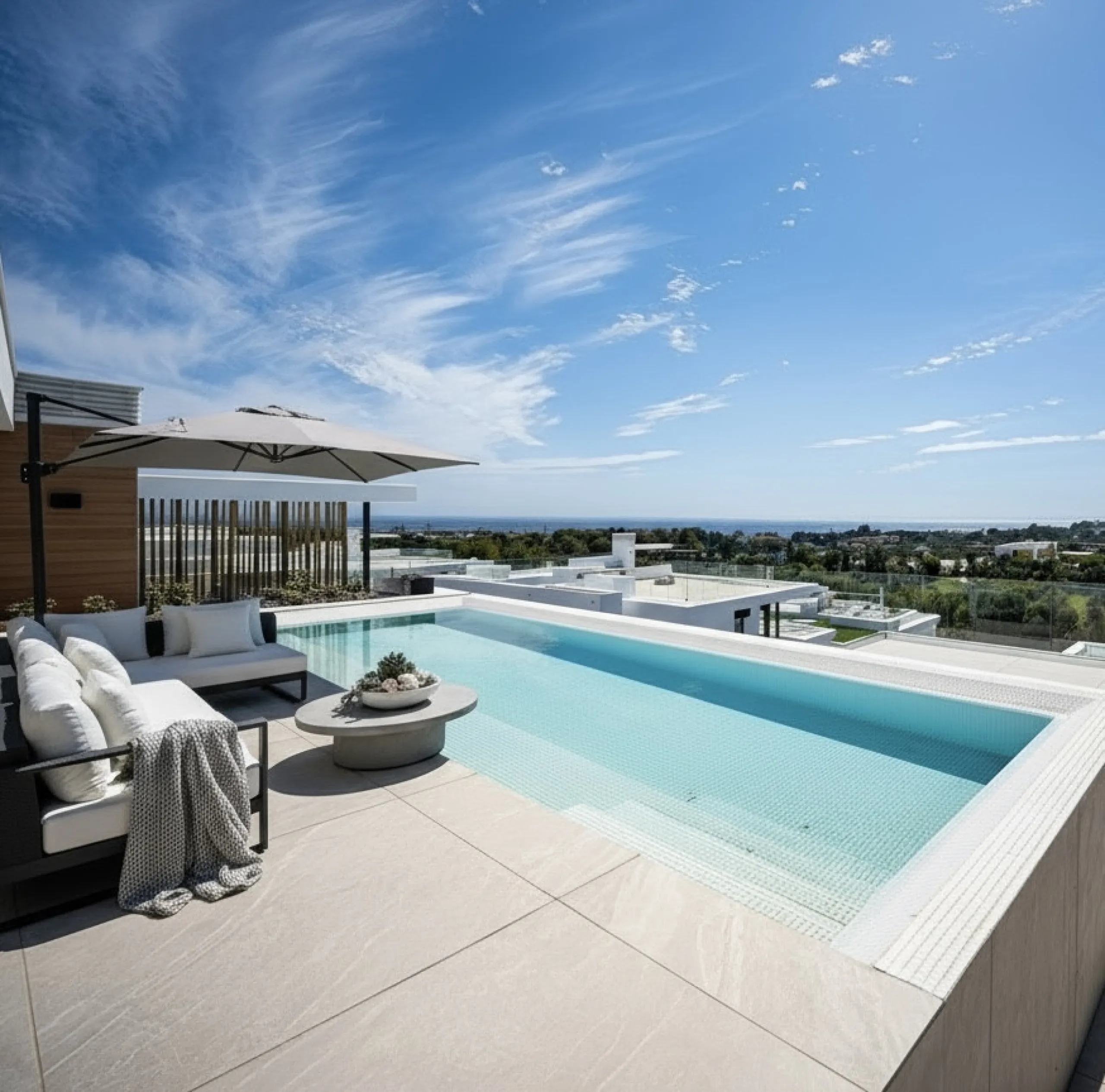 Penthouse Alma is a brand-new duplex home in a secure gated community in Marbella East. It has two ensuite bedrooms, a guest bathroom, and an open-plan living space that connects the kitchen, dining, and lounge areas. Floor-to-ceiling windows fill the hom