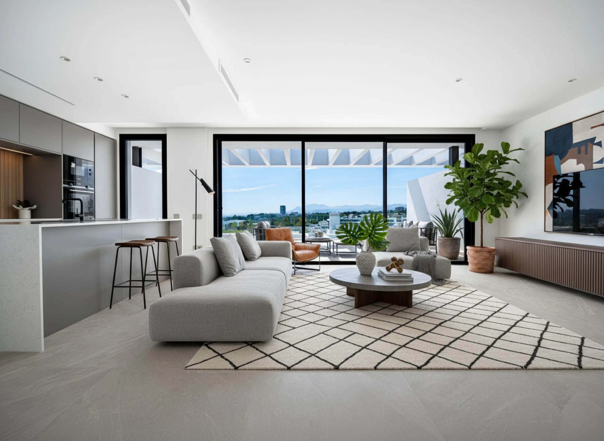 Penthouse Alma is a brand-new duplex home in a secure gated community in Marbella East. It has two ensuite bedrooms, a guest bathroom, and an open-plan living space that connects the kitchen, dining, and lounge areas. Floor-to-ceiling windows fill the hom