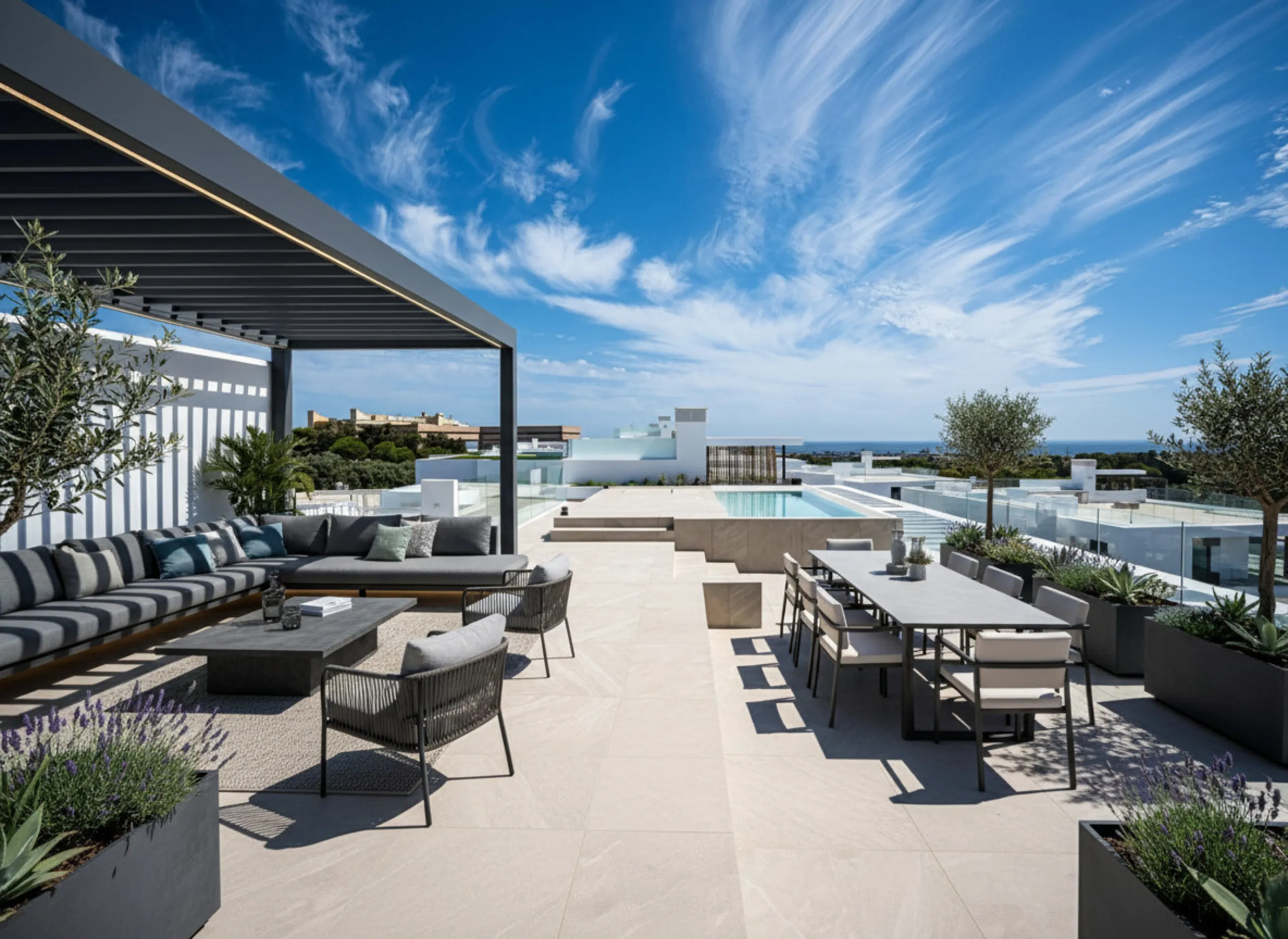 Penthouse Alma is a brand-new duplex home in a secure gated community in Marbella East. It has two ensuite bedrooms, a guest bathroom, and an open-plan living space that connects the kitchen, dining, and lounge areas. Floor-to-ceiling windows fill the hom