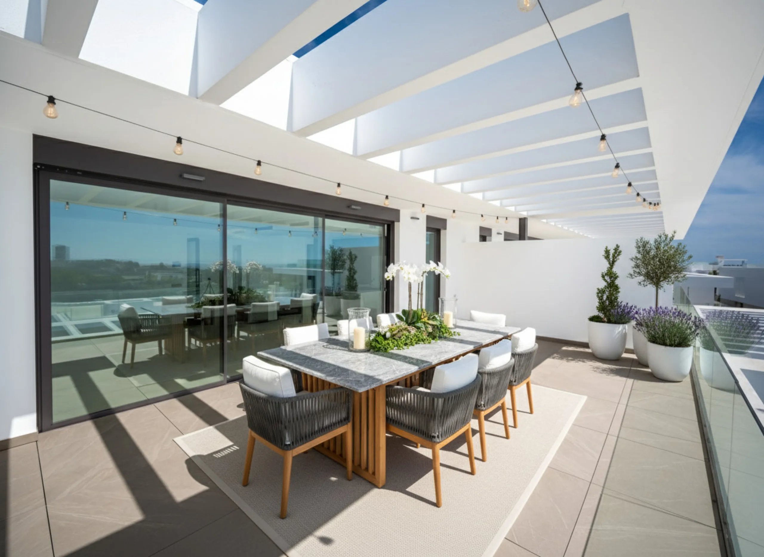 Penthouse Alma is a brand-new duplex home in a secure gated community in Marbella East. It has two ensuite bedrooms, a guest bathroom, and an open-plan living space that connects the kitchen, dining, and lounge areas. Floor-to-ceiling windows fill the hom