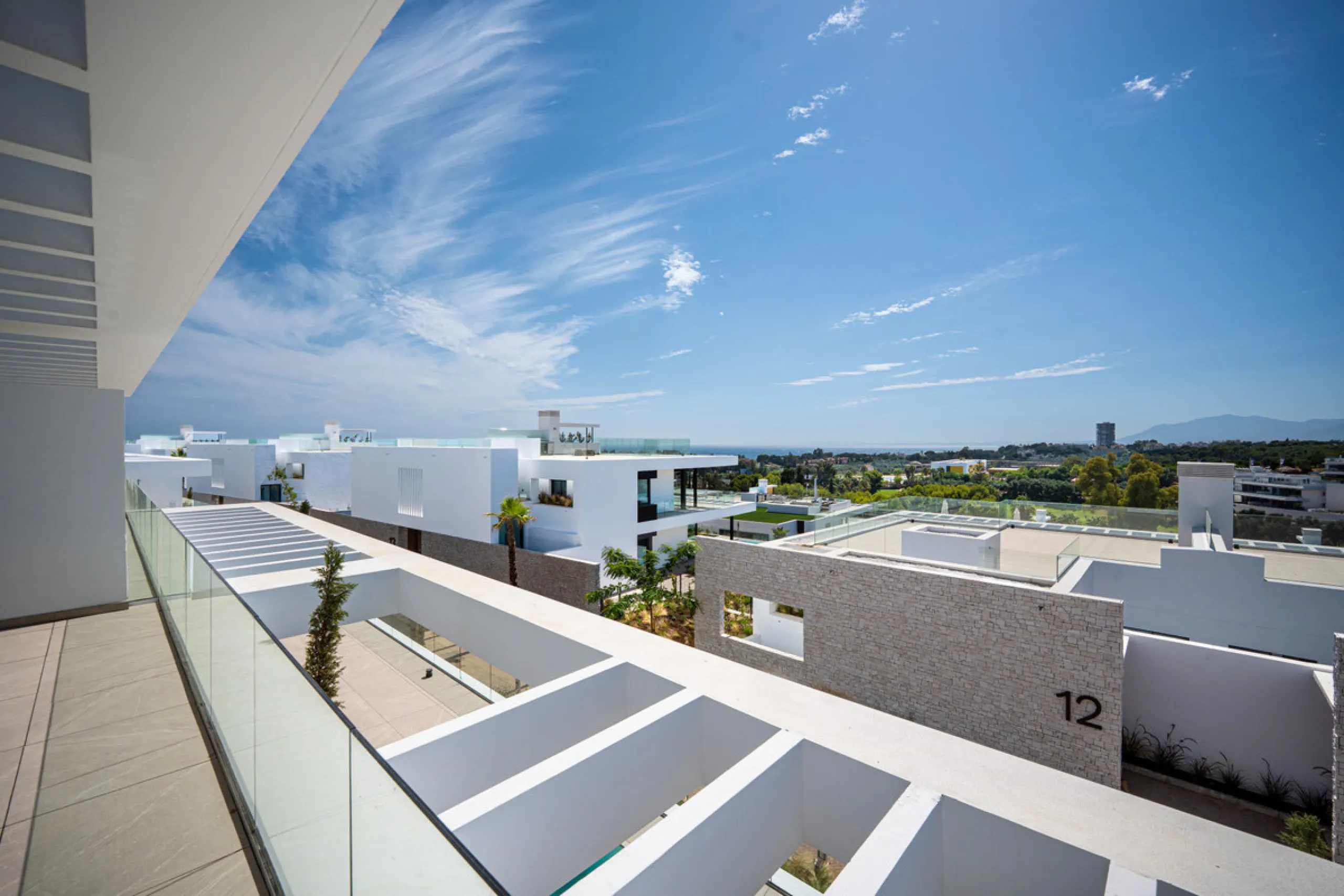 Penthouse Alma is a brand-new duplex home in a secure gated community in Marbella East. It has two ensuite bedrooms, a guest bathroom, and an open-plan living space that connects the kitchen, dining, and lounge areas. Floor-to-ceiling windows fill the hom