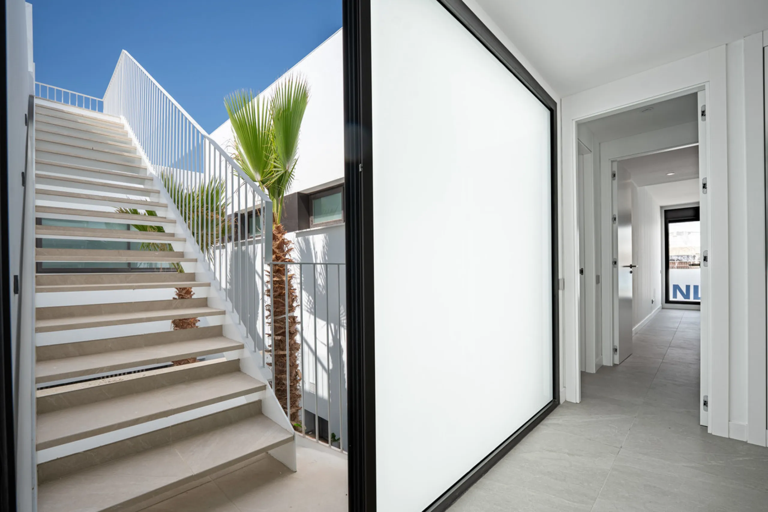 Penthouse Alma is a brand-new duplex home in a secure gated community in Marbella East. It has two ensuite bedrooms, a guest bathroom, and an open-plan living space that connects the kitchen, dining, and lounge areas. Floor-to-ceiling windows fill the hom
